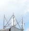 Cell phone antenna in a building against blue sky