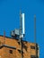 Cell phone antenna, transmitter. Telecom radio mobile antenna against blue sky