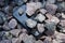 Cell phone with broken glass on gravel granite stones, unbreakable gadget