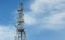 Cell phone communications tower against blue sky