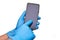 Cell phone held by a man or doctor with surgical latex gloves