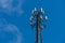 Cell phone or mobile service tower providing broadband internet service against blue sky