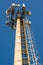 Cell tower against the blue sky. Lower angle