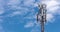 Cell tower on blue sky background. Floating clouds in blue sky, time lapse. cell tower 5G