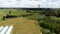 Cell tower, cellular base station aerial shot, drone view cloudy sky, telecommunication tower on a field, rural area, countryside