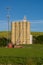 Cell tower and grain silo with green field