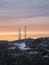 Cell towers in the snow-covered hills in tundra. Beautiful sunset hilly landscape of the Arctic