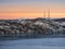 Cell towers in the snow-covered hills in tundra. Beautiful sunset hilly landscape of the Arctic