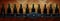 Cellar shelf with dark corked wine bottles against light brown wooden wall.