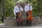 Cellist musician group perform music in the street, close up man playing violin