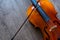 The cello and its bow are on a wooden background. Top view. Rehearsal before the concert. Musical tuition concept