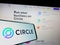 Cellphone with logo of American payment company Circle Internet Financial Ltd on screen in front of website.