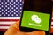Cellphone with WeChat logo in front of the flag of America.