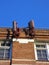 Cellular antenna painted to look like red bricks mounted to the