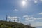 Cellular antennas against a blue sky and sun