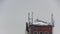 Cellular antennas on the roof of a residential house covered with snow