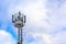 Cellular communication tower on a background of cloudy sky. Soft focus. Concept: communication and broadcasting, business, mobile