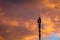 Cellular communications tower on vivid dramatic clouds background in evening, copy space