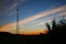 Cellular tower silhouette at sunset