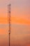 Cellular transmitter, folded dipole radio antenna for telecommunications with colorful sky background. Silhouette amateur radio