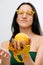Cellulite is consequence of poor nutrition. Nutritionist holding measuring tape with orange fruit, panorama