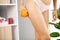 Cellulite problem concept, young woman holding orange near her leg