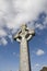 Celtic cross in an irish graveyard with blue sky