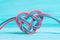 Celtic knot shape made from pink and blue cords