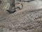 Cement mixer construction site / cement mortar mixer with hoe on basin water for construction glue tiled on ground background