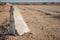 Cement road beacon on the side of a deserted desert road