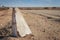 Cement road beacon on the side of a deserted desert road