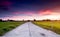 Cement road in the green field at the country side.