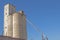 Cement silos with piping and blue sky