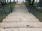 Cement stairs with railing leading to asphalt