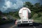 Cement transport truck on a highway between mountains in Colombia.