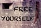 Cement wall with the word Free Yourself