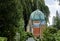 Cemetery with the chapel behind the graves in front of a big willow tree