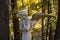 Cemetery gothic angel sculpture in autumn forest park