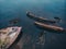 Cemetery of old ships Teriberka Murmansk Russia, wooden remains of industrial fishing boats in sea. Industrialization