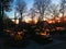 Cemetery at sunset. Burning candles on the graves