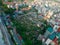 Cemetery surrounding by dense of multistory residential houses caged balcony, row of high-rise apartment tower complex background