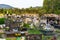 Cemetery with traditional granite graves decorated with colorful artificial flowers and candles, Poland.