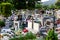 Cemetery with traditional granite graves decorated with colorful artificial flowers and candles, Poland.