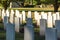 Cemetery with white graves on green grass