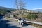 cenic view of road by landscape with mountain, road and blue sky seen through motor bike