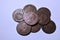 Cenital view of a pile of european coins from the eighteenth century with white background