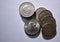 Cenital view of a pile of five peseta coins from 1949 and white background