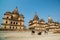 Cenotaphs at Orchha, Madhya Pradesh. Also spelled Orcha, famous travel destination in India. Cows, blue sky, wide angle.