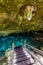 Cenote Dos Ojos in Quintana Roo, Mexico. People swimming and snorkeling in clear water. This cenote is located close to Tulum in