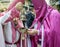 Censer in the hands of a penitent being lit by another penitent in the Easter Week Procession of La Borriquita on Palm Sunday in Z